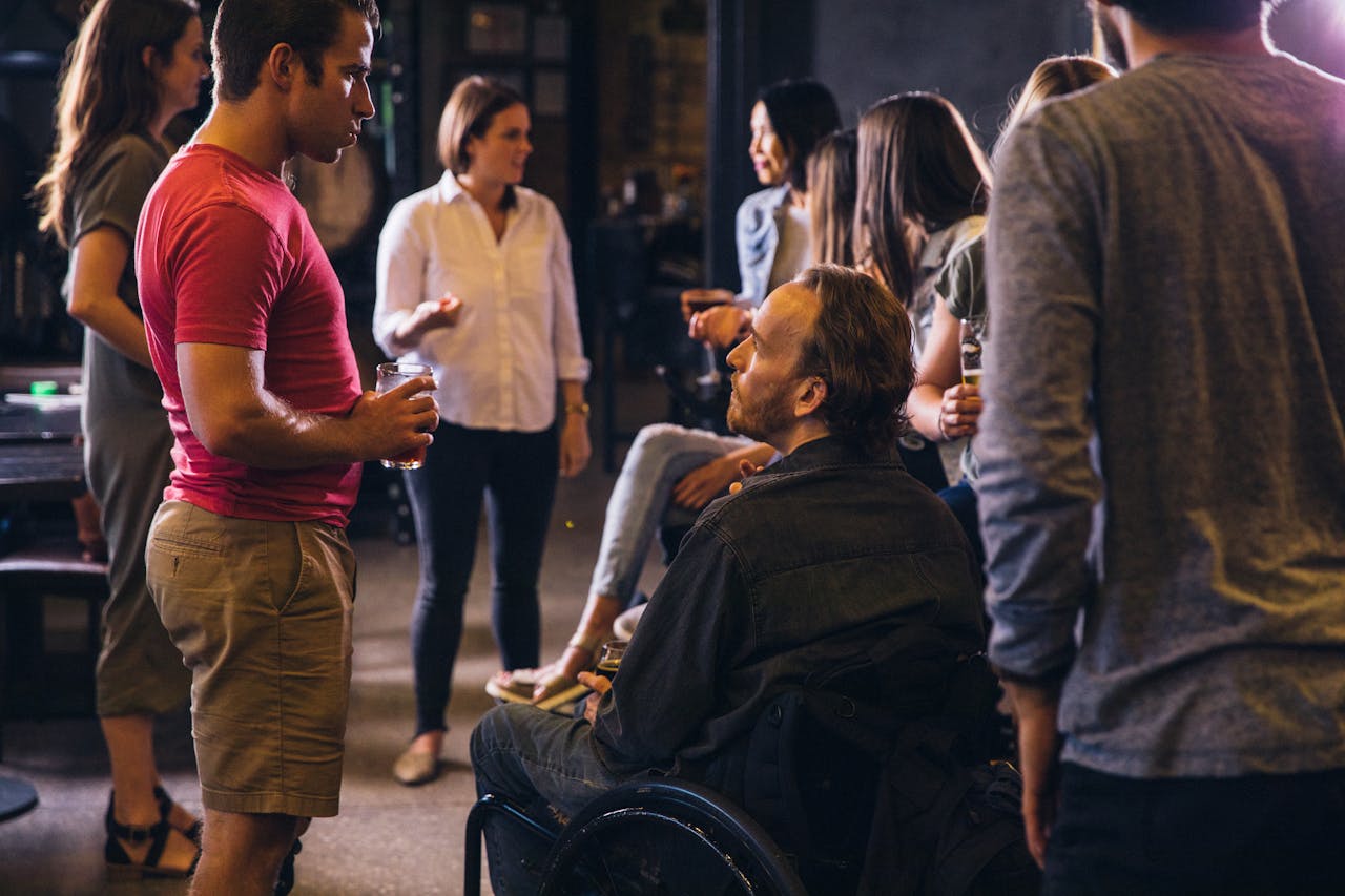 why-choose-us-02 A diverse group socializing in a modern bar setting, promoting inclusion.